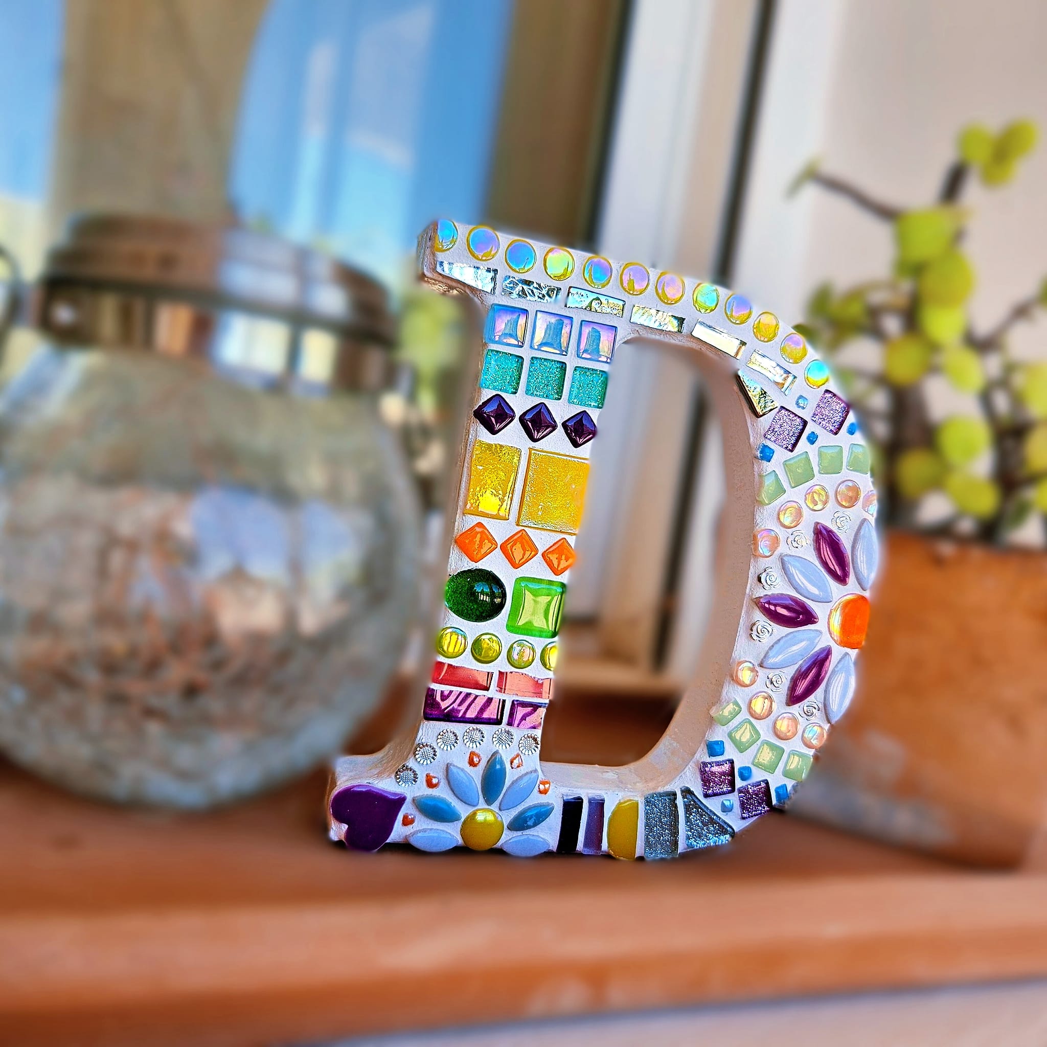 Decorative mosaic letter D.