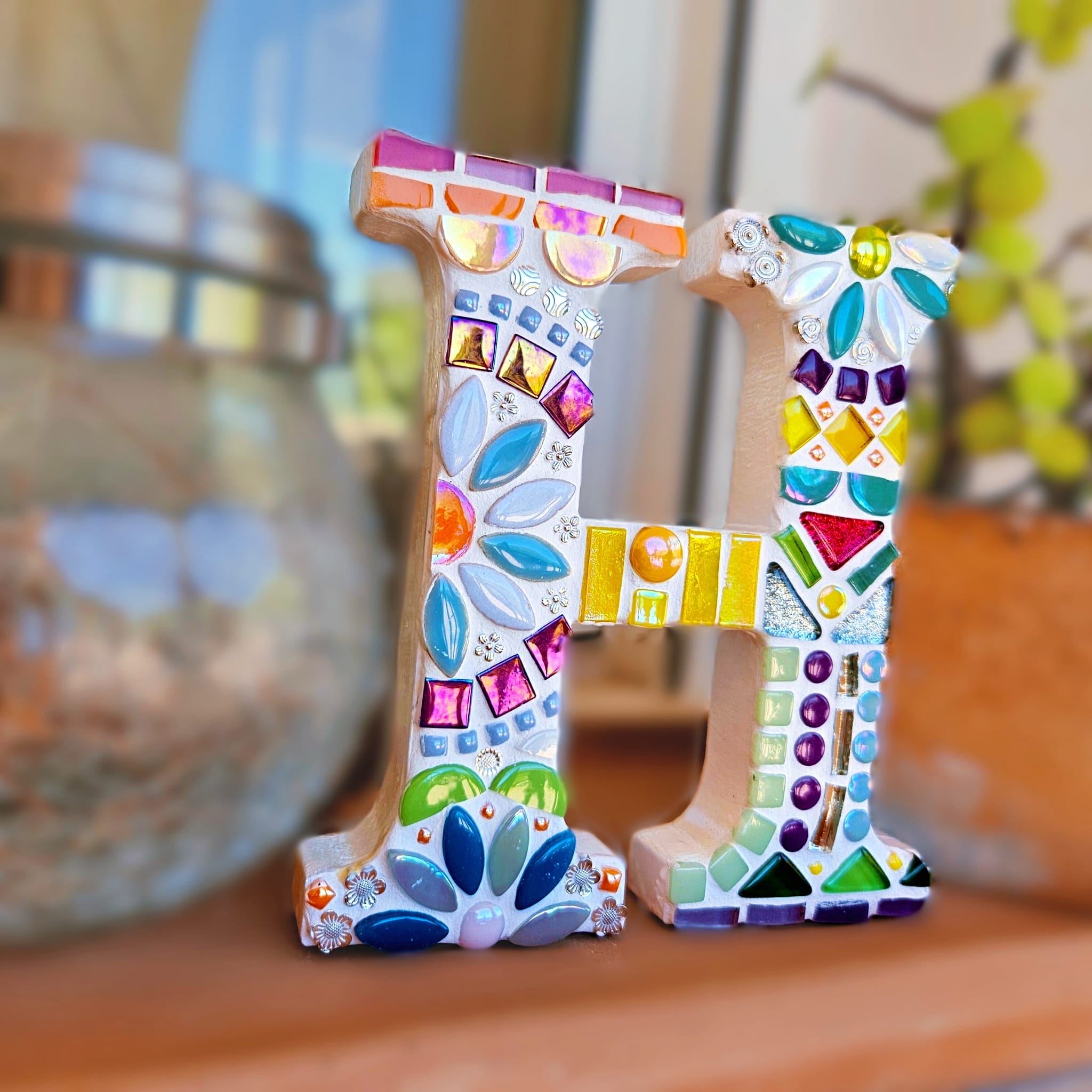 Decorative mosaic letter H.