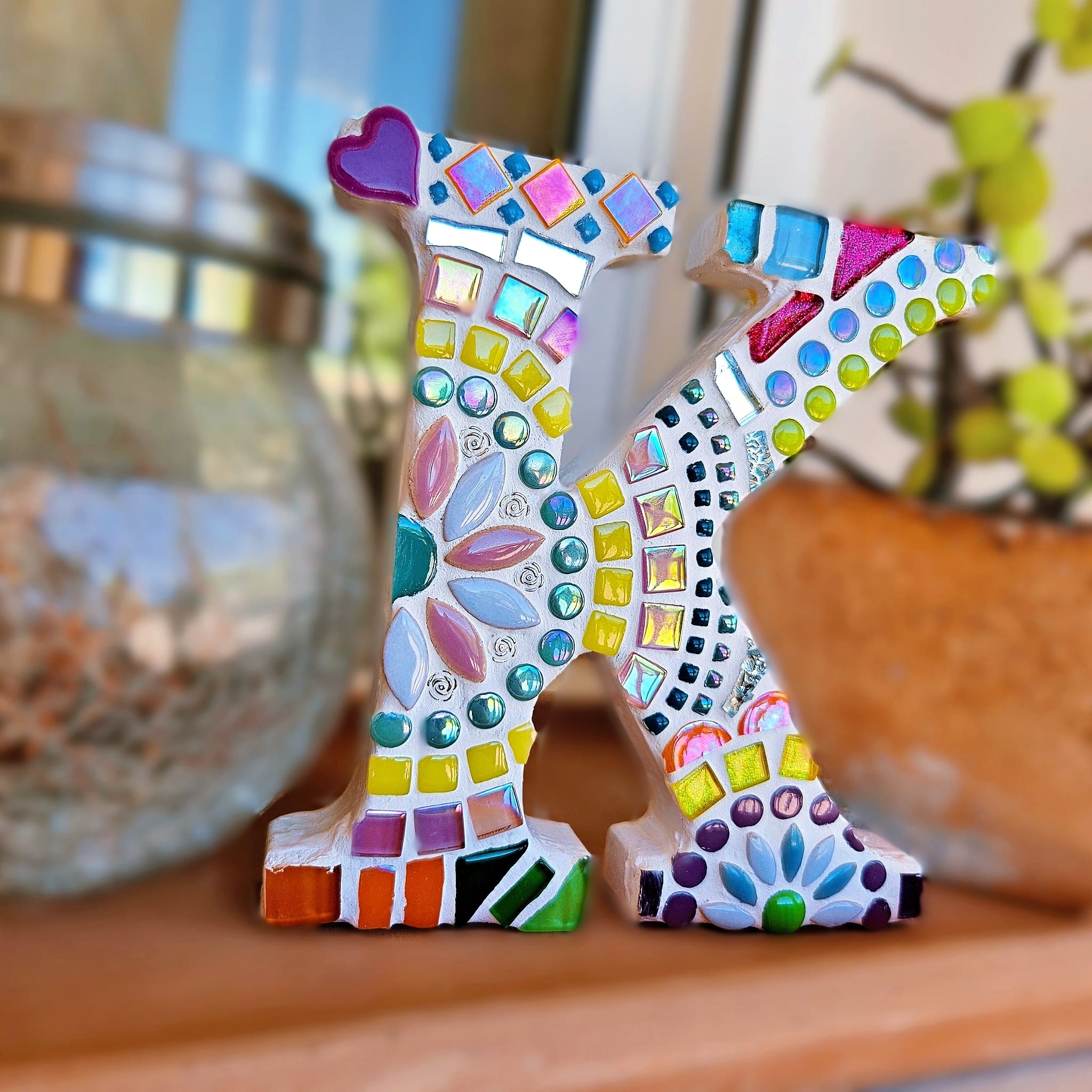 Decorative mosaic letter K.