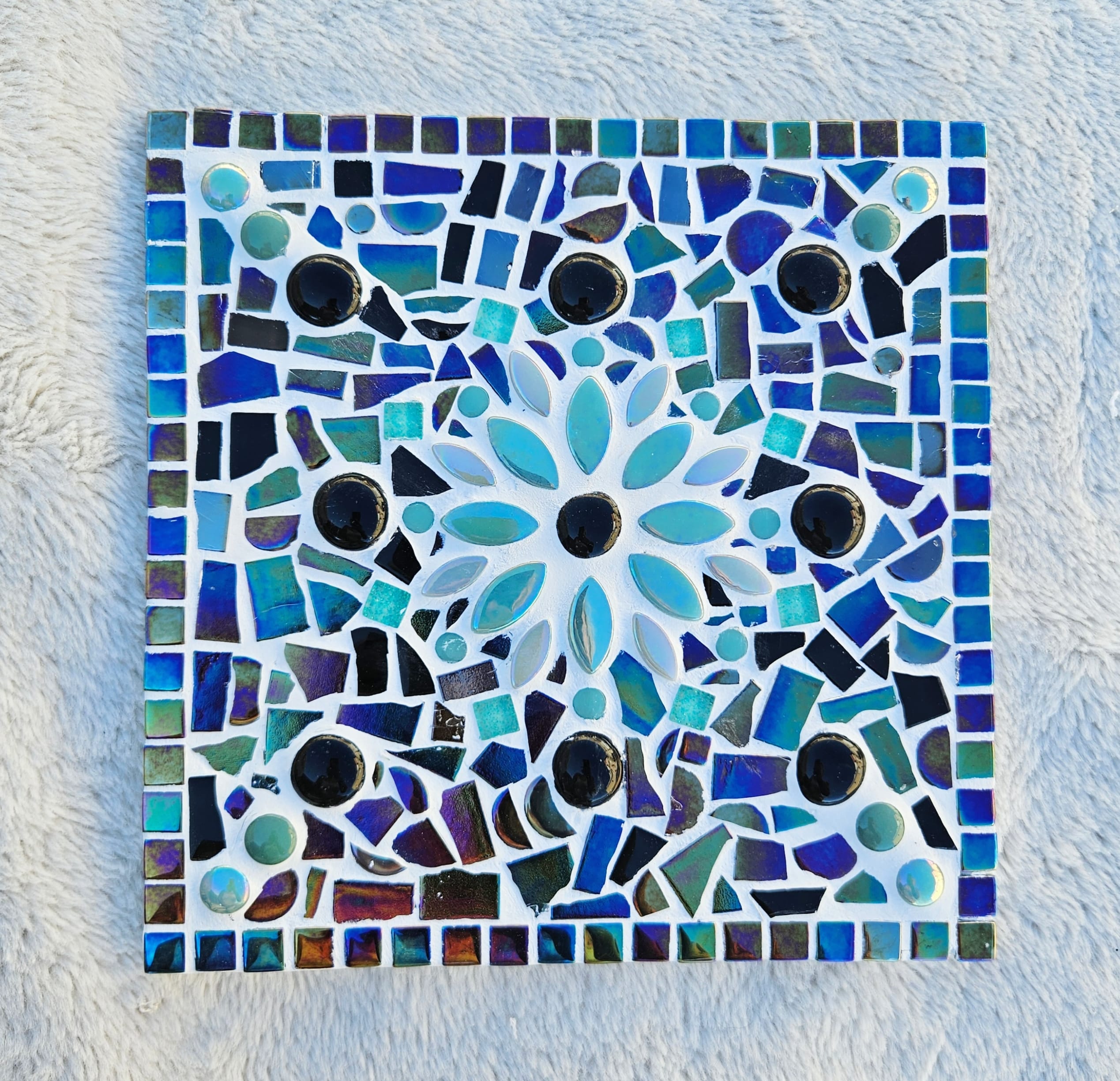 Turquoise mosaic flower tile.