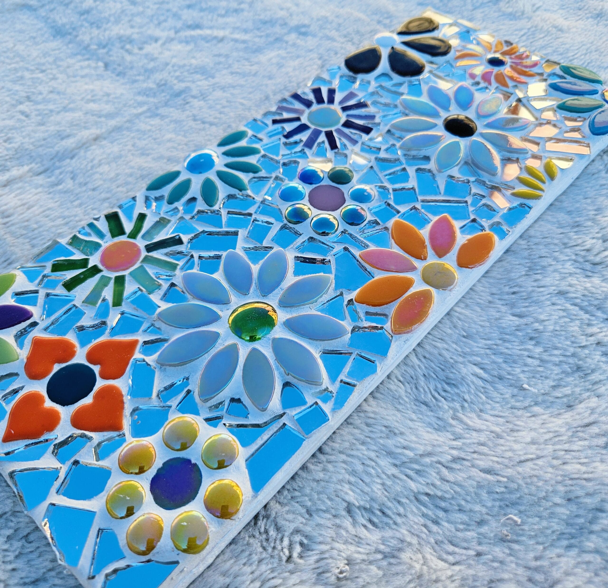 Mirrored mosaic flower tile.