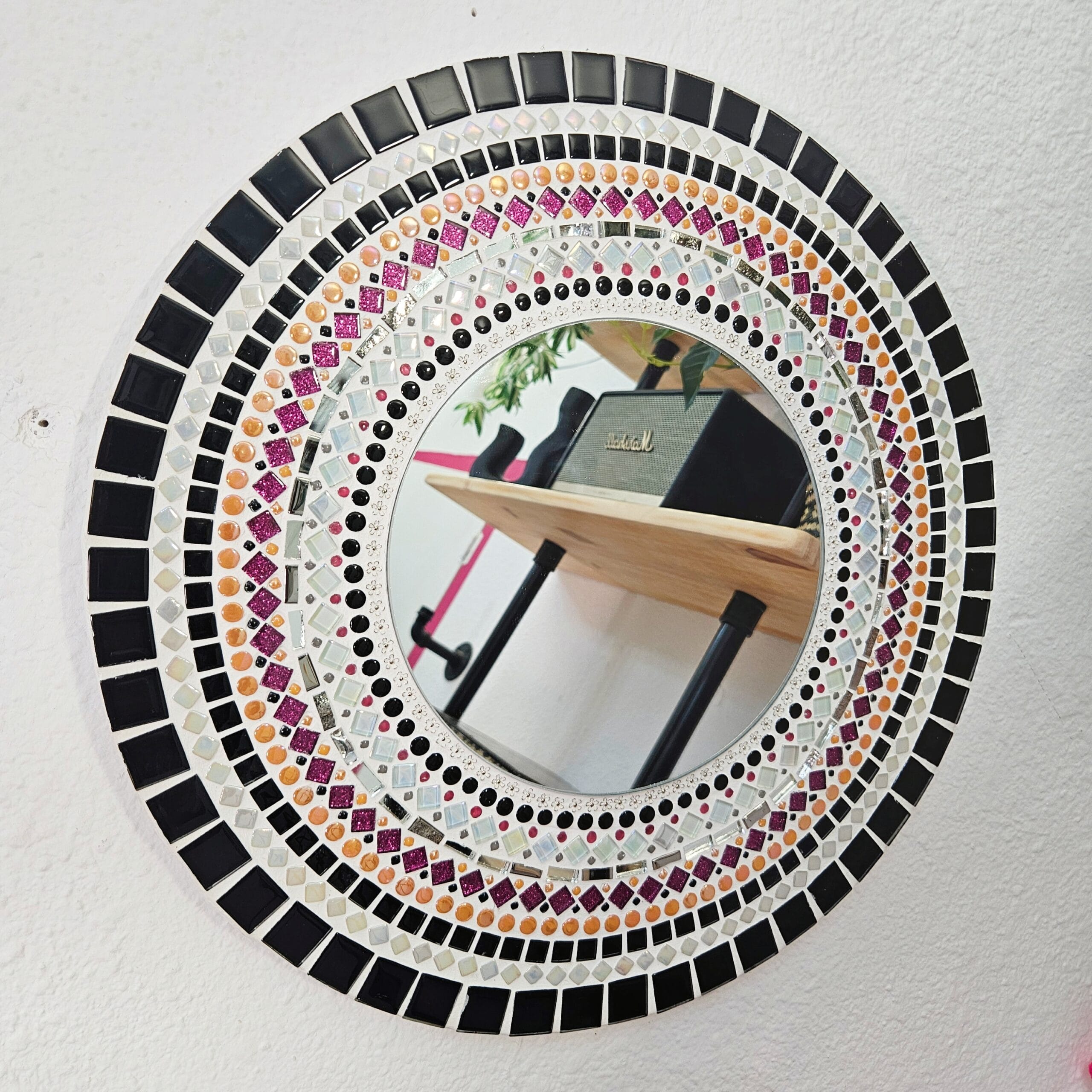 Black and orange mosaic mirror.