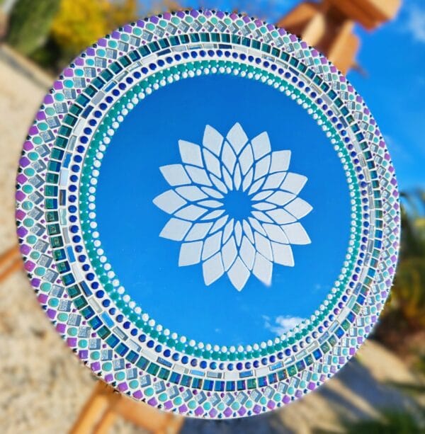 Mosaic mirror with painted dot work and etched mandala pattern.