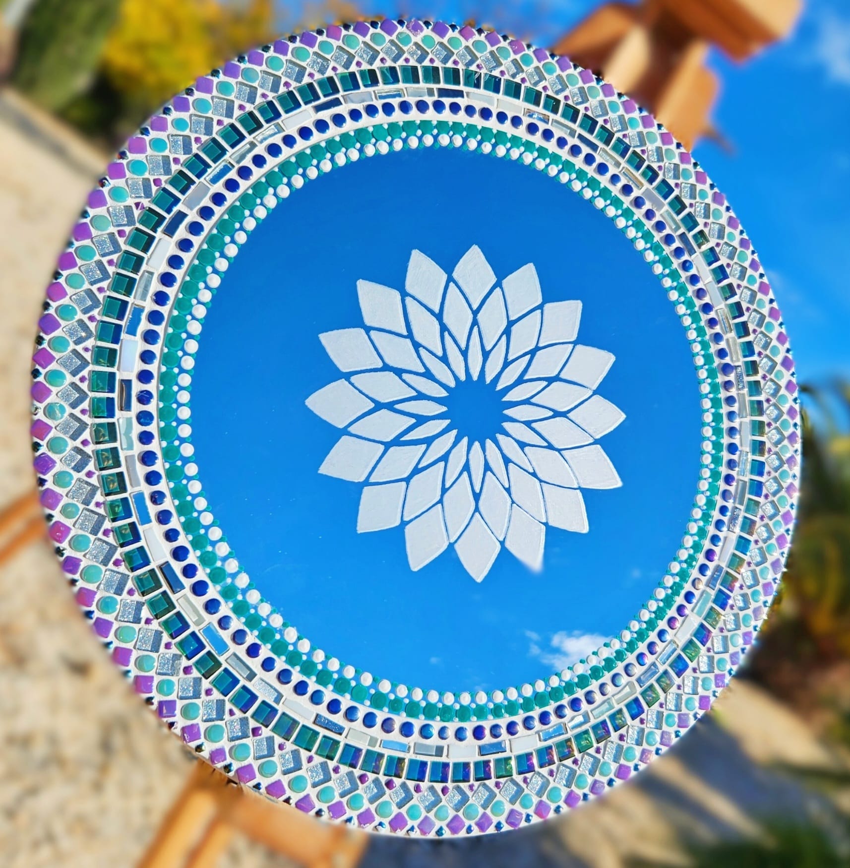Mosaic mirror with painted dot work and etched mandala pattern.
