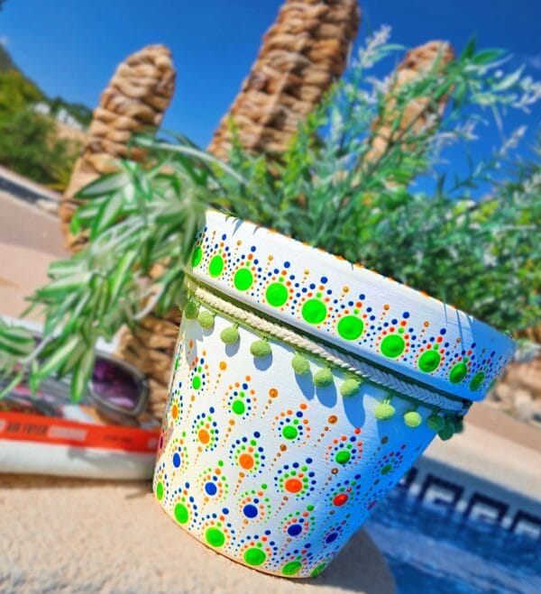 Large white and green plant pot with green trim.