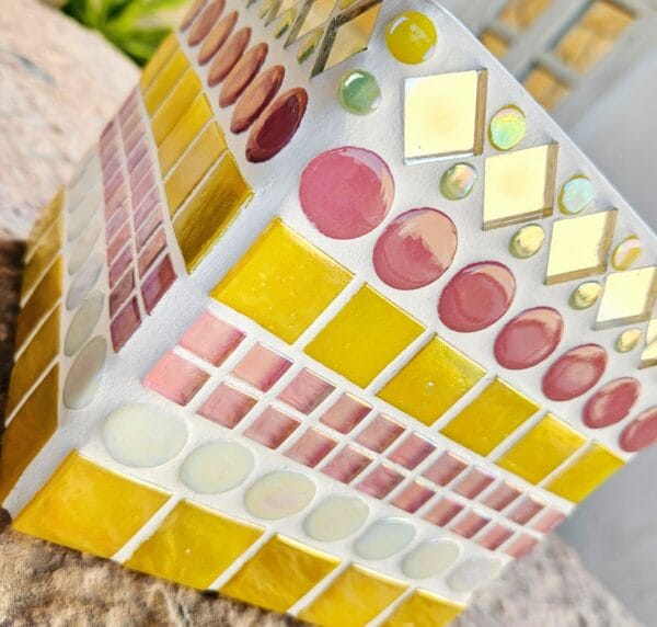 Decorative yellow and pink mosaic plant pot.