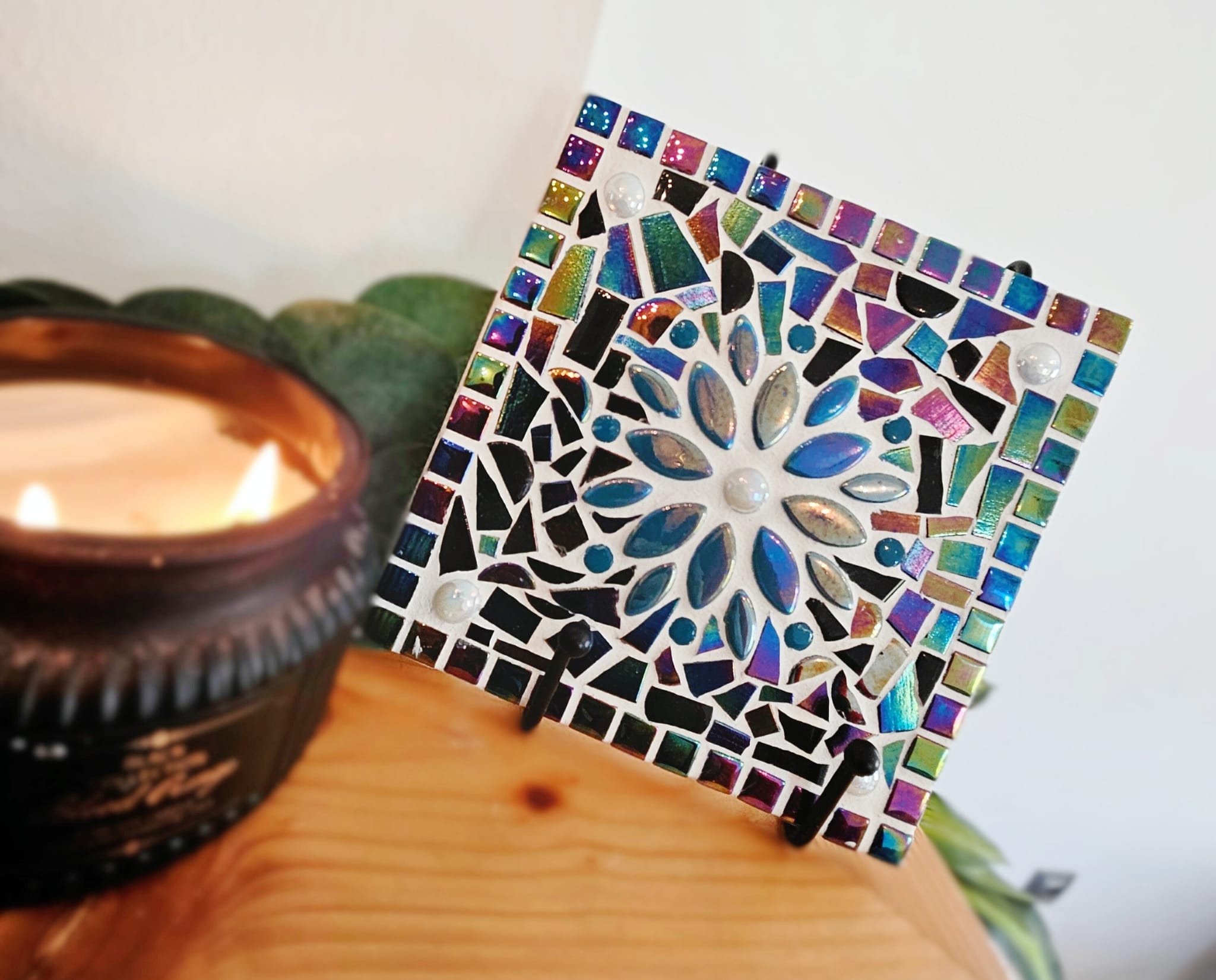 Colourful mosaic tile with turquoise flower.
