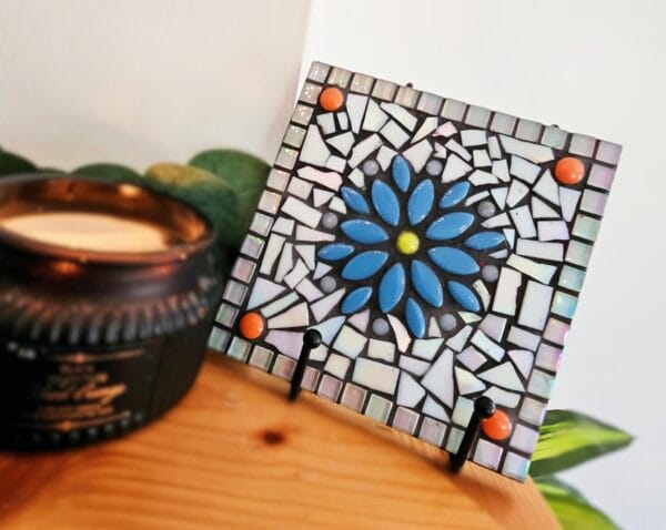 Mosaic colourful tile with blue flower.