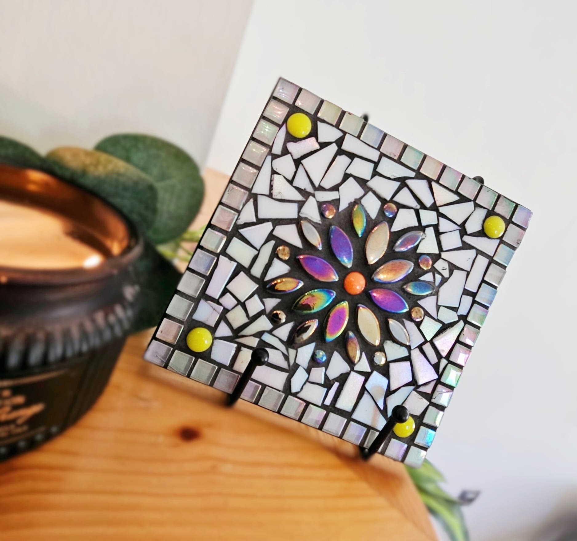 Colourful mosaic tile with iridescent flower.