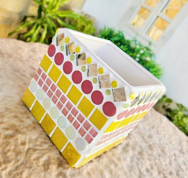 Decorative yellow and pink mosaic plant pot.
